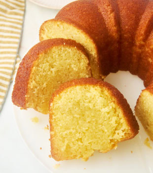 partially sliced Kentucky butter cake on a white cake plate