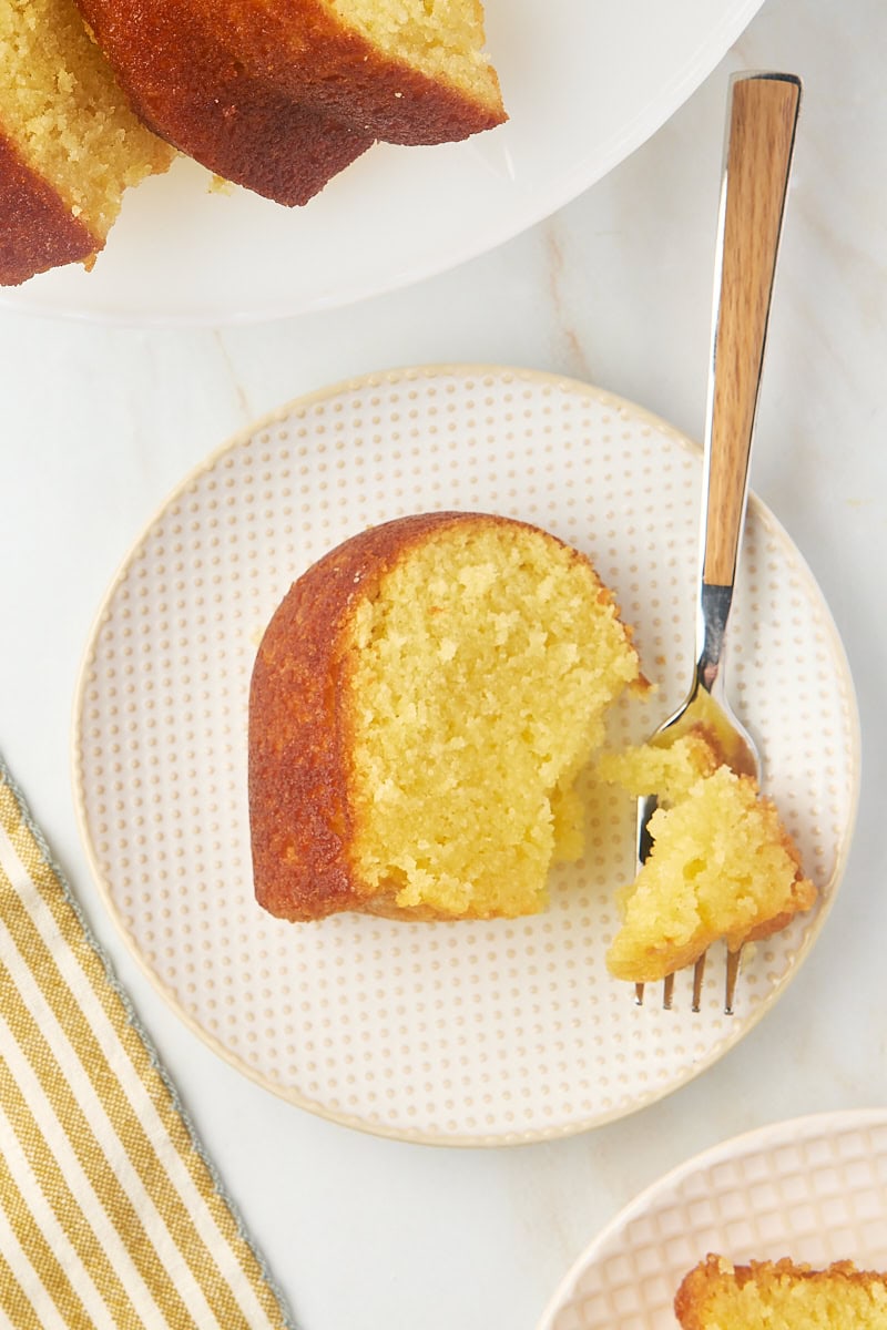 overhead view of a slice of Kentucky butter cake on a plate with a bite on a fork