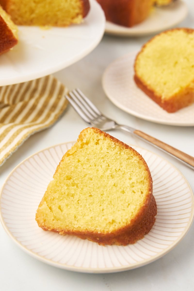 a slice of Kentucky butter cake on a plate with more cake in the background