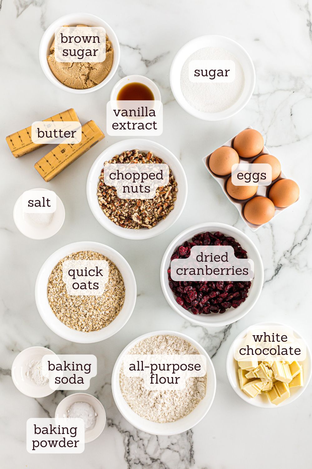 overhead view of labeled ingredients for oatmeal cranberry cookies