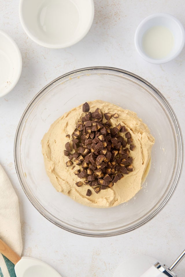 overhead view of chopped peanut butter cups added to peanut butter dip