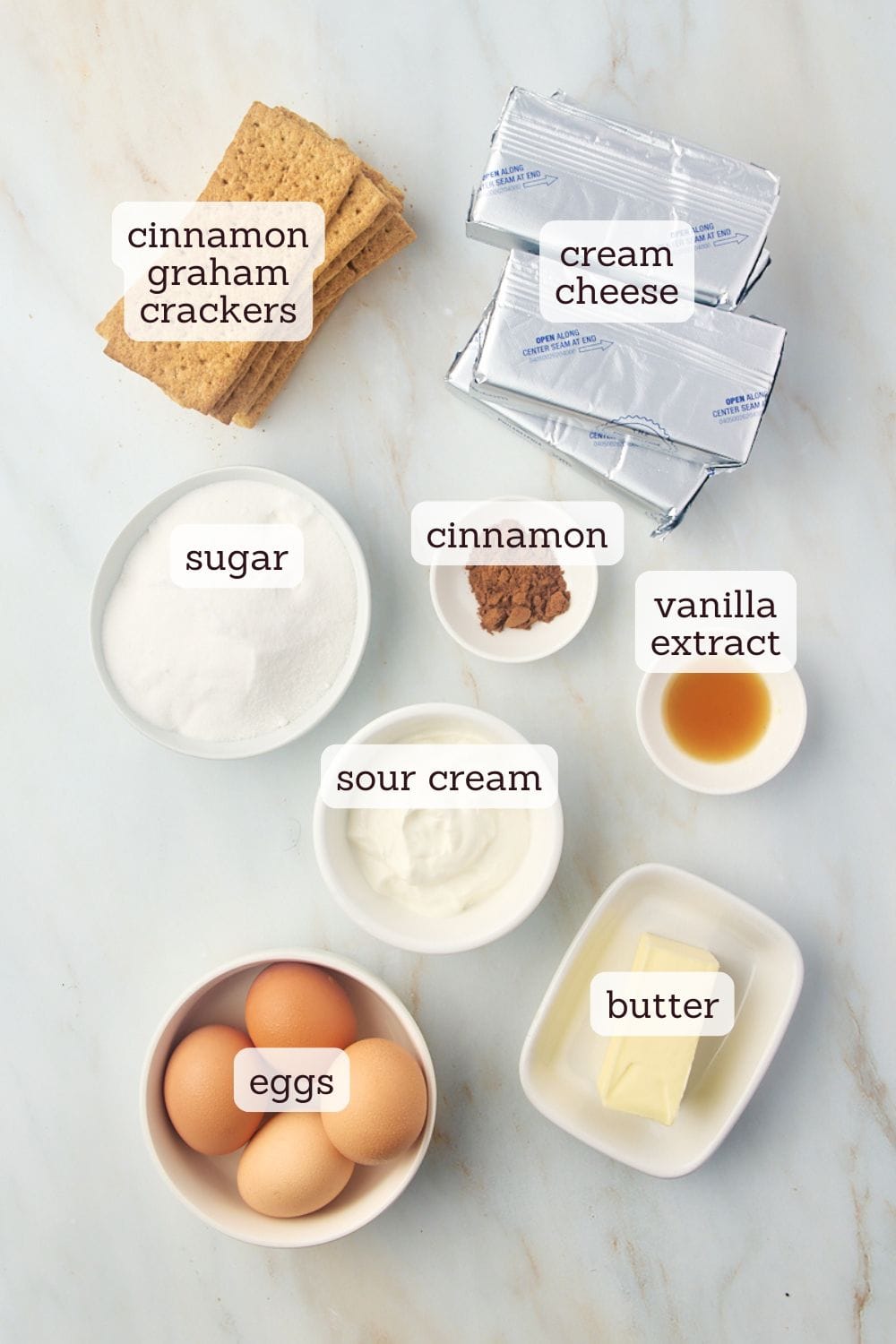 overhead view of labeled ingredients for snickerdoodle cheesecake