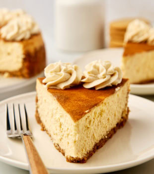 a slice of snickerdoodle cheesecake on a plate with a fork