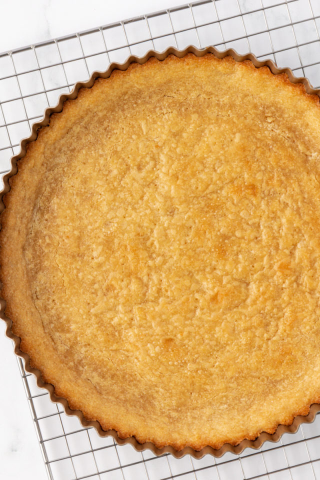 overhead view of freshly baked tart crust on a wire rack