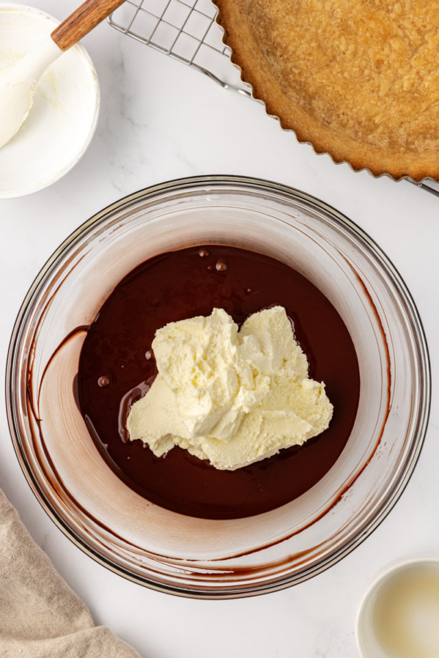 overhead view of mascarpone and liqueur added to melted chocolate