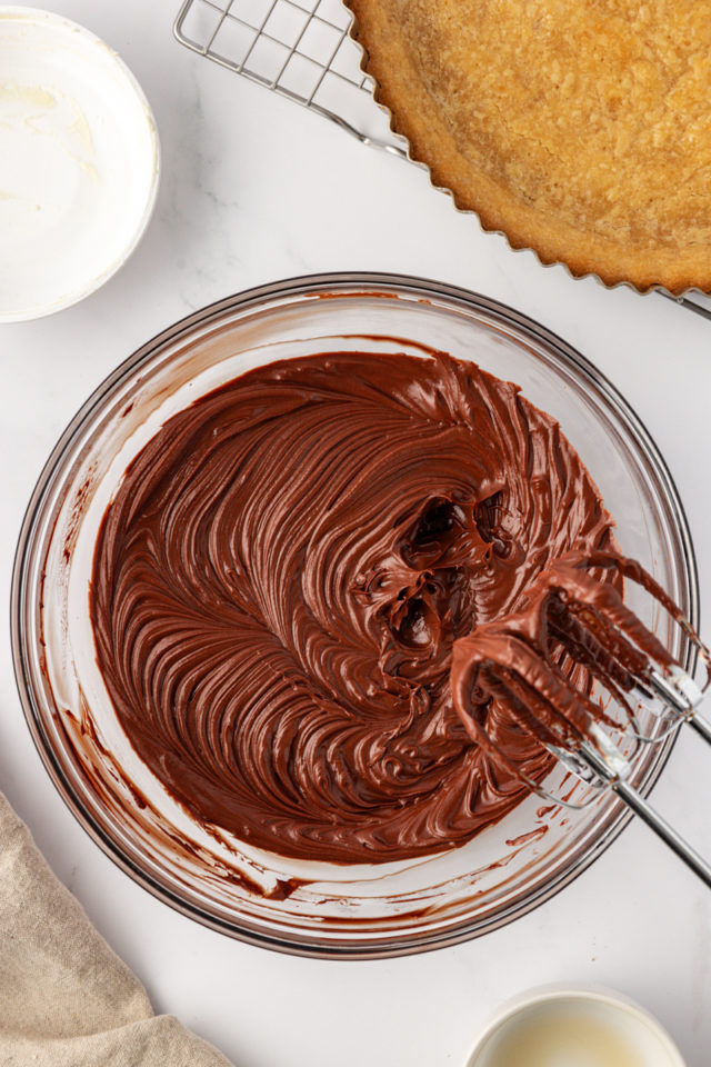 overhead view of chocolate ganache tart filling in a glass bowl