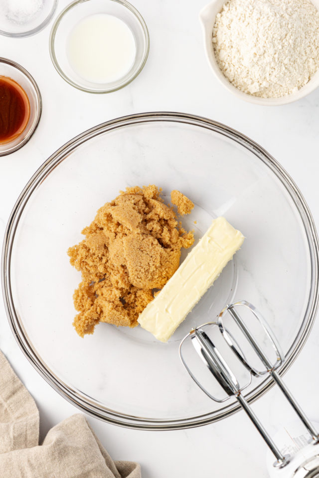 overhead view of butter and brown sugar in a glass mixing bowl