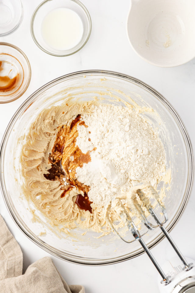 overhead view of flour, vanilla, and salt added to creamed butter and brown sugar