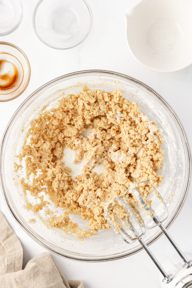 overhead view of milk added to tart crust dough