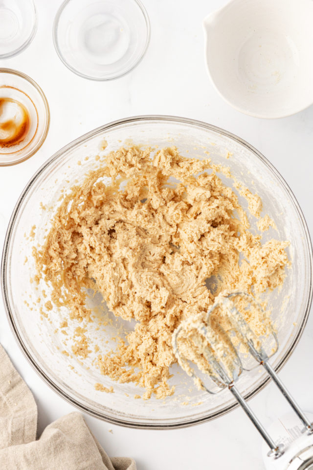 overhead view of tart crust dough in a glass mixing bowl