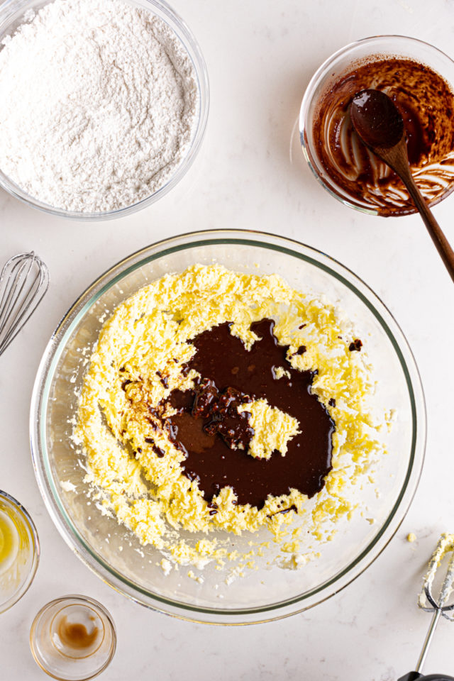 Adding chocolate mixture to creamed butter and sugar