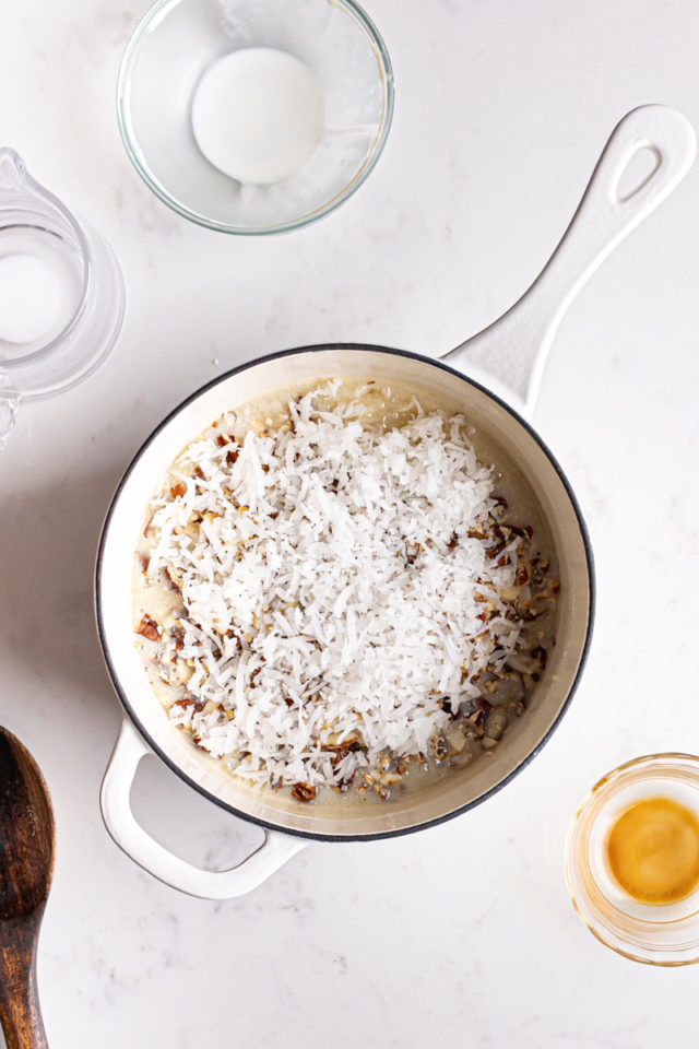 Coconut added to pan of German chocolate cheesecake frosting