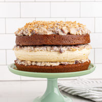 Layered German chocolate cheesecake on cake stand