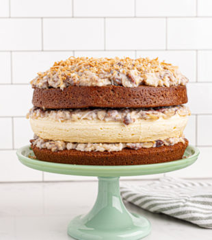 Layered German chocolate cheesecake on cake stand