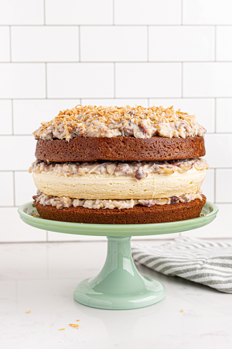 Layered German chocolate cheesecake on cake stand