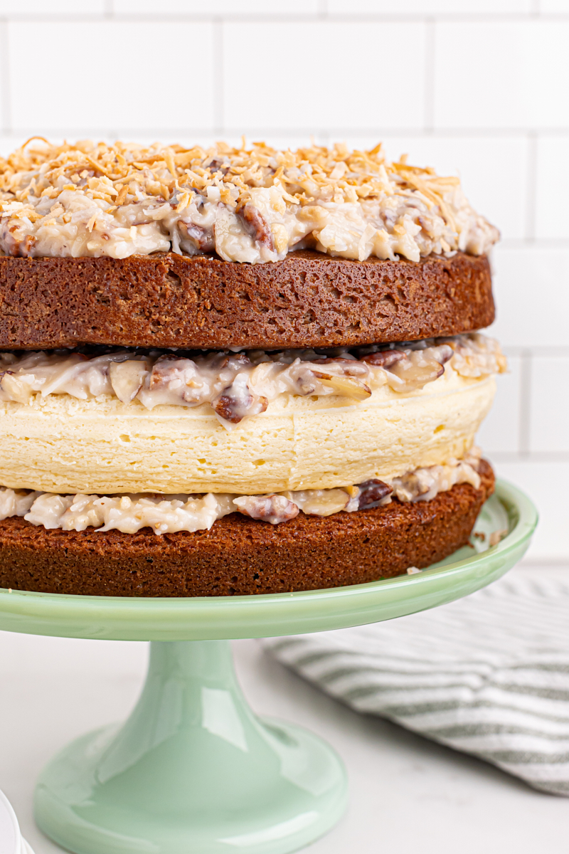 Layered German chocolate cheesecake on cake stand