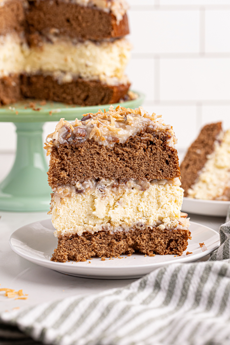 Slice of German chocolate cheesecake standing upright on plate