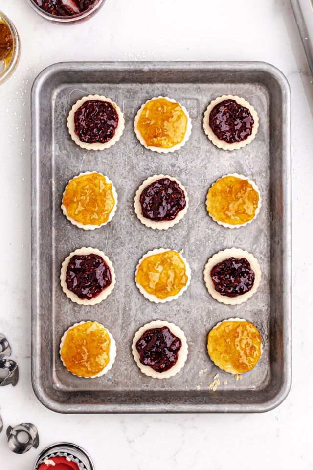 overhead view of jam spread on the bottom cookies for Linzer cookies