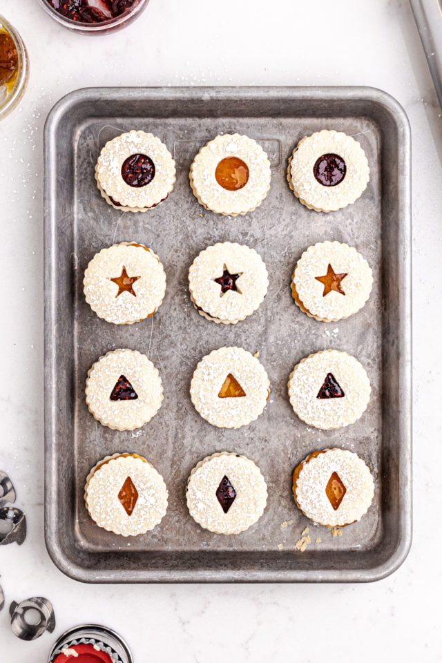 overhead view of assembled Linzer cookies on a sheet pan