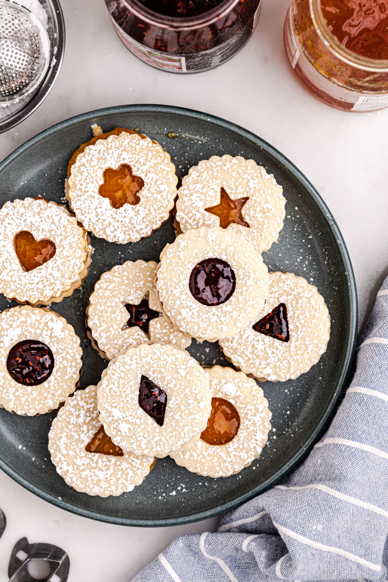 overhead view of Linzer cookies on a dark gray plate