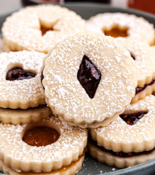 Linzer cookies served on a dark gray plate