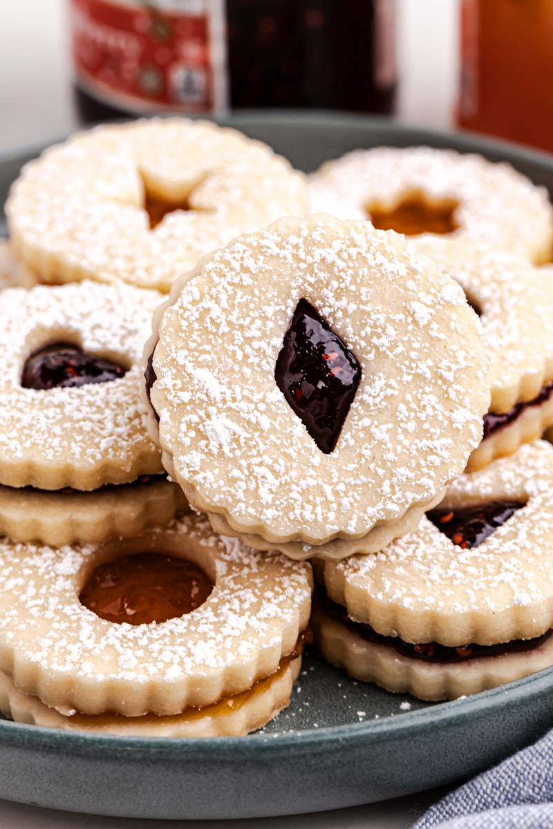 Linzer cookies served on a dark gray plate