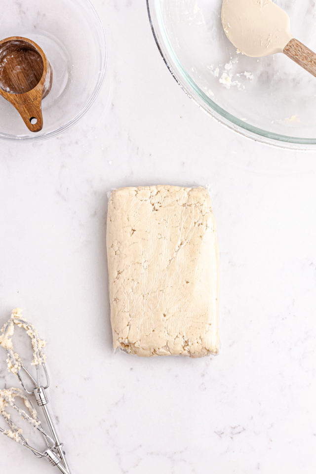 Linzer cookie dough shaped into a rectangle ready to be chilled