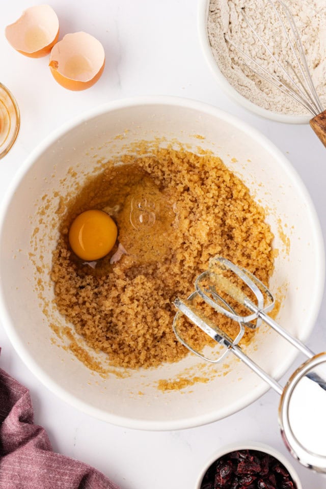 overhead view of egg and vanilla added to sweetened macadamia mixture