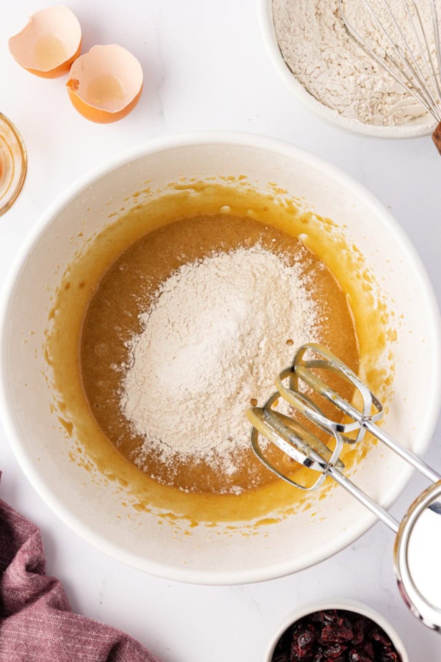 overhead view of dry ingredients added to wet ingredients for macadamia butter cookies