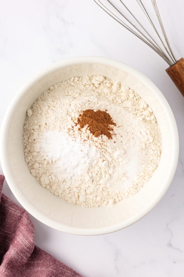 overhead view of flour, baking soda, and salt in a white bowl