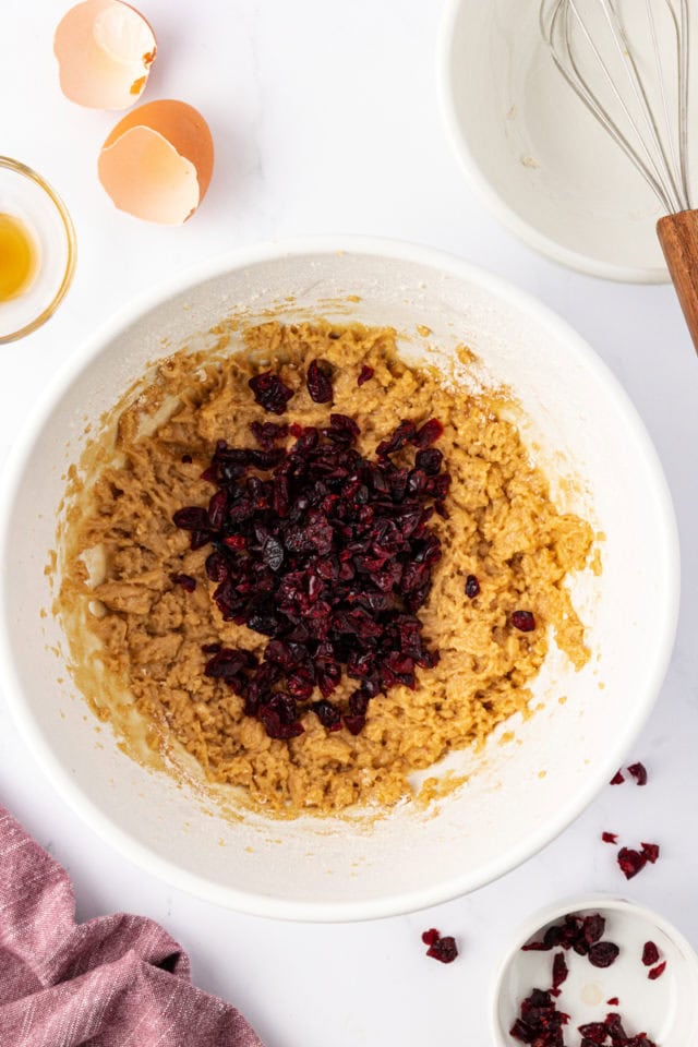 overhead view of cranberries added to macadamia butter cookie dough