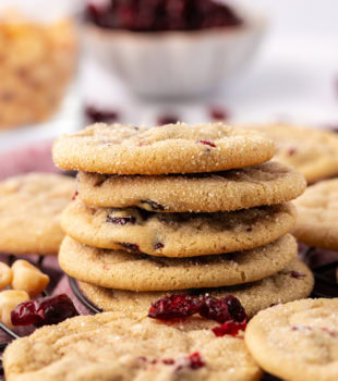 stack of macadamia butter cookies surrounded by more cookies
