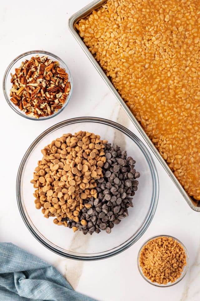 overhead view of chocolate chips and peanut butter chip in a glass mixing bowl