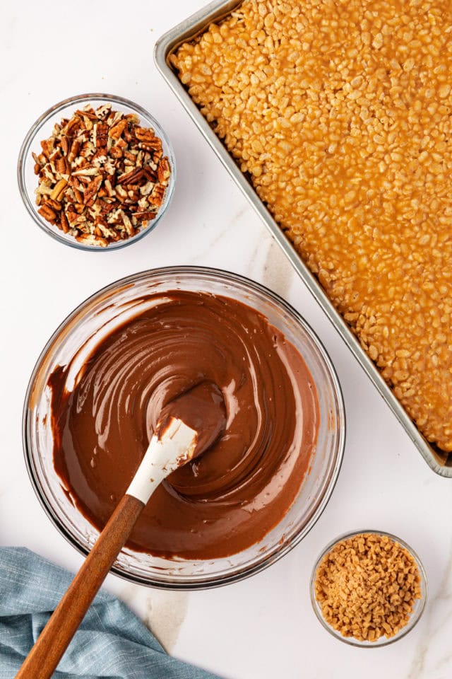 overhead view of melted chocolate and peanut butter baking chips in a glass mixing bowl