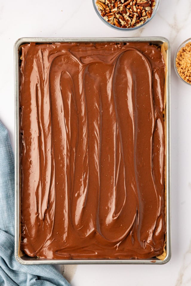 overhead view of chocolate-peanut butter topping added to chocolate peanut butter cereal bars