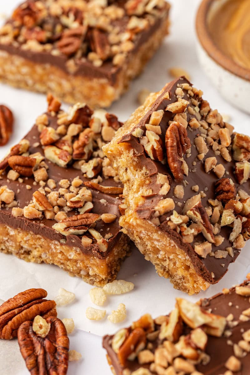 a chocolate peanut butter cereal bar leaned against another bar