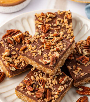 chocolate peanut butter cereal bars on a white plate