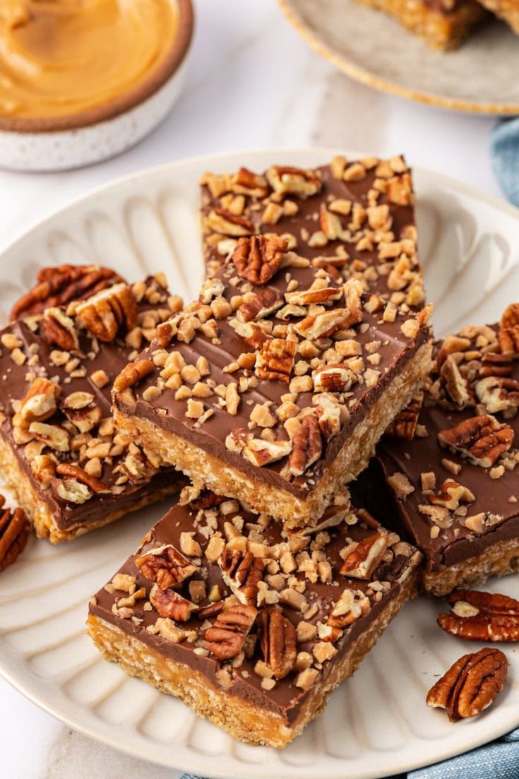 chocolate peanut butter cereal bars on a white plate