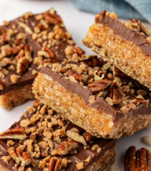 overlapping chocolate peanut butter cereal bars on parchment paper