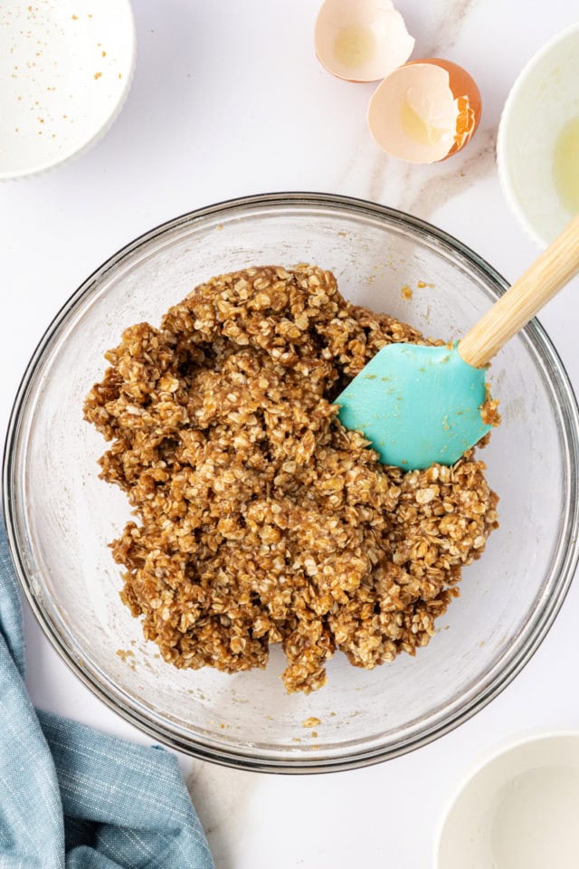 overhead view of crust mixture for chocolate peanut butter cereal bars in a glass bowl