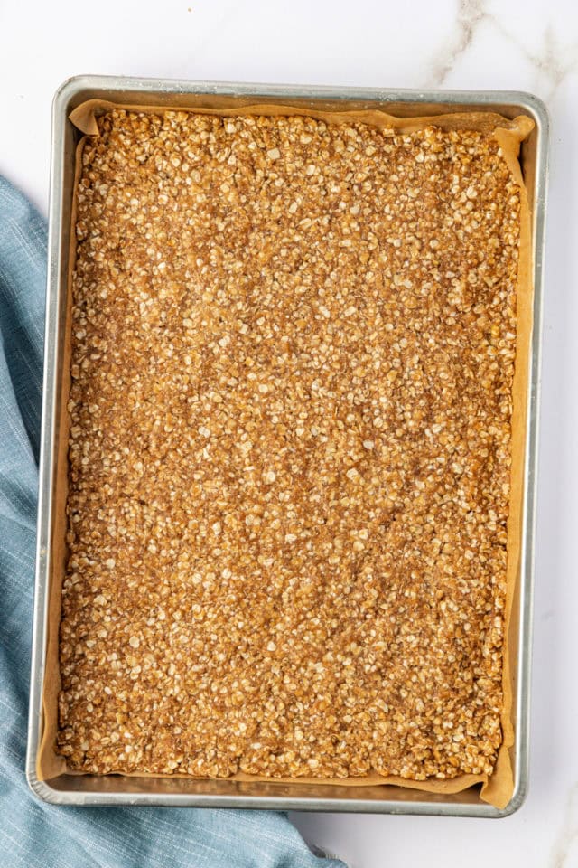 overhead view of oat crust spread in a jellyroll pan