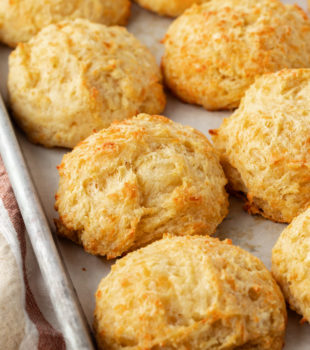 three cheese biscuits on a baking sheet