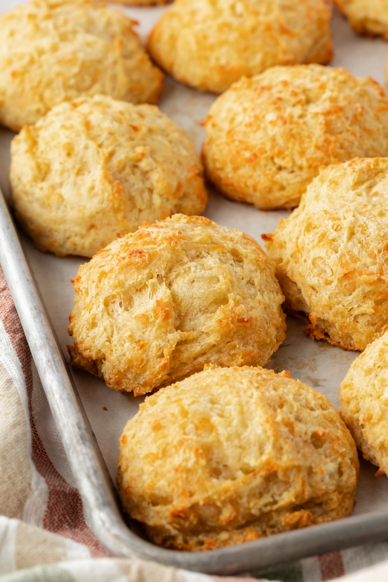 three cheese biscuits on a baking sheet