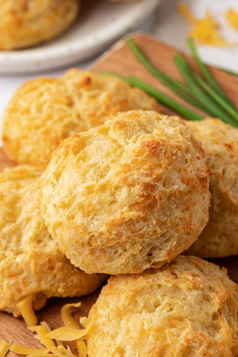 three cheese biscuits on a wooden board