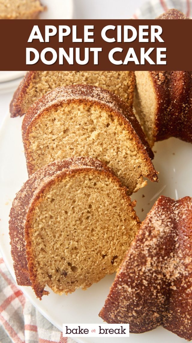 partially sliced apple cider donut cake on a white cake stand; text overlay "apple cider donut cake"