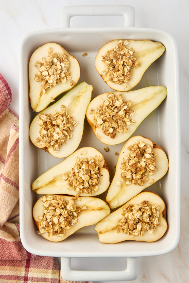 overhead view of baked pears filled with oat mixture and ready to go into the oven