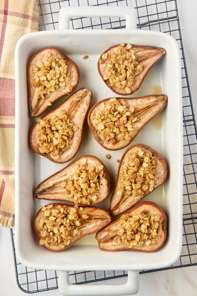 overhead view of fresh baked pears in a white baking dish set on a wire rack