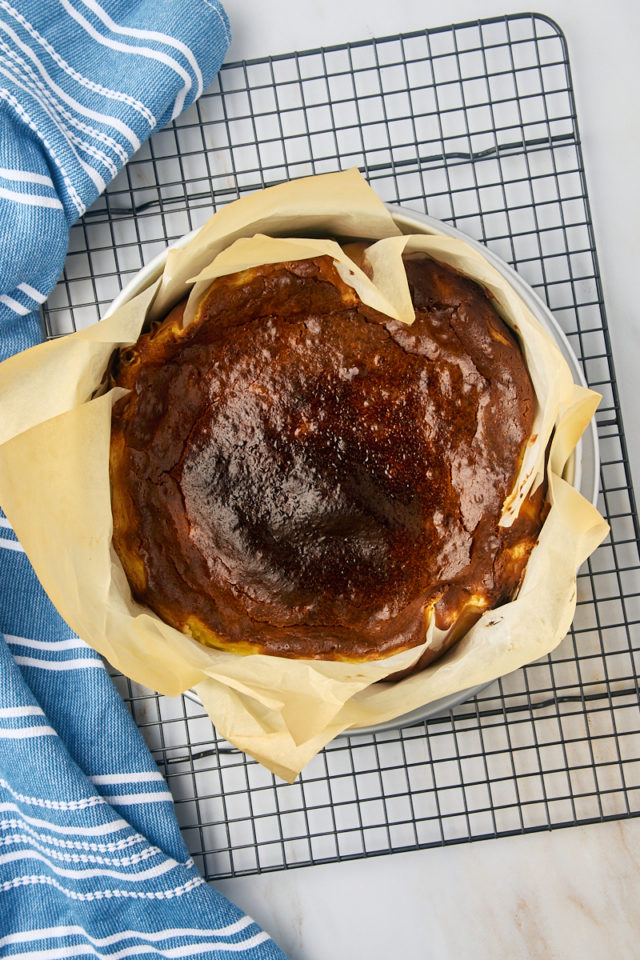 overhead view of freshly baked basque cheesecake on a wire rack