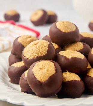 buckeyes on a white plate with more in the background