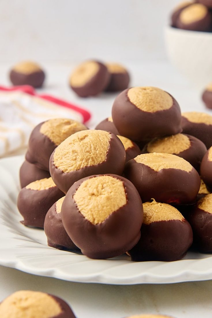 buckeyes on a white plate with more in the background